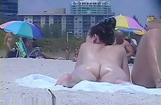 Tanned pierced marvelous babe getting recorded on the nudist beach